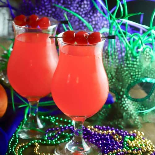 Twoo hurricane cocktails with Mardi Gras beads.