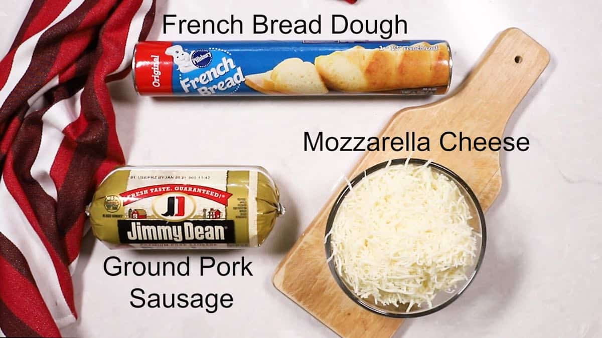 A can of French bread dough, sausage and mozzarella cheese. 