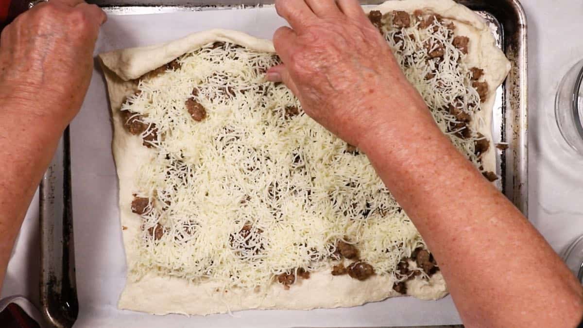 Rolling up dough to form a log. 