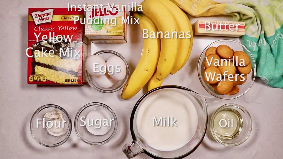 Ingredients for a banana pudding cake including cake mix and bananas. 