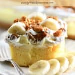 Pinterest Pin showing a slice of banana pudding poke cake topped with crushed vanilla wafers.