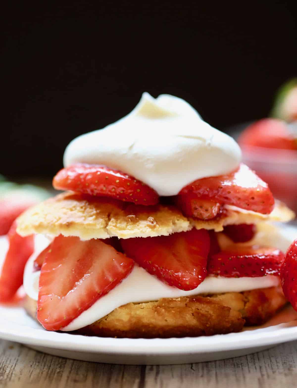 Southern strawberry shortcake on a plate with fresh strawberries. 