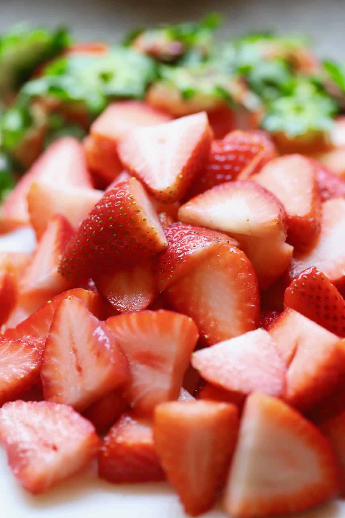 Sliced strawberries in a bowl.