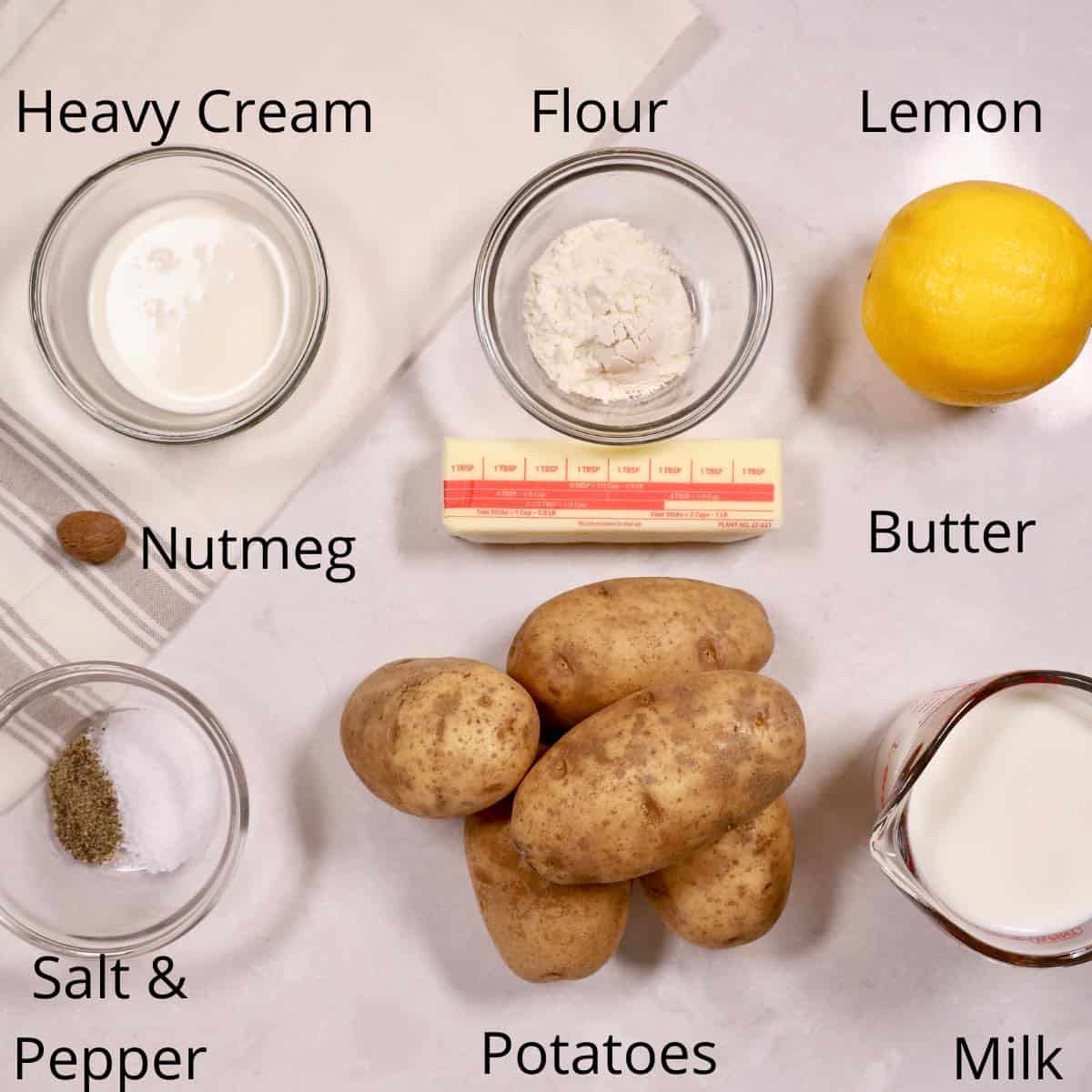 Ingredients for creamed potatoes including potatoes, milk and nutmeg. 