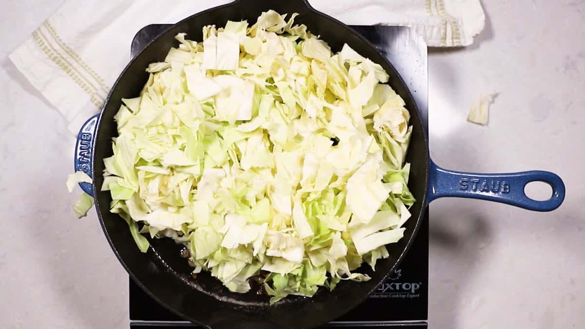 Cooking cabbage in a cast-iron skillet.