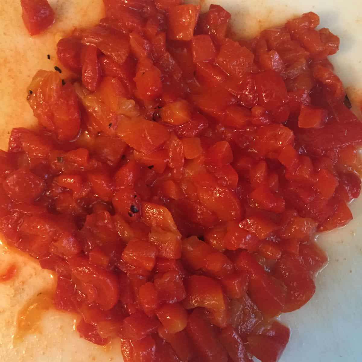 Minced roasted red bell pepper on a cutting board. 