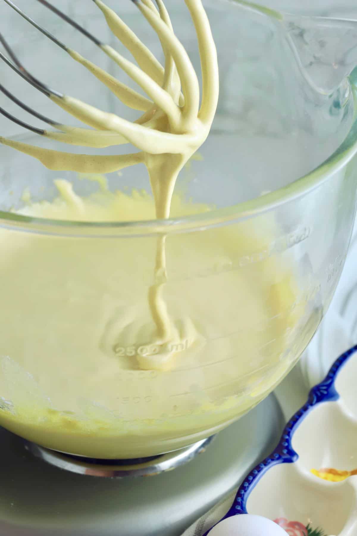 Egg yolks in the bowl of an electric mixer.