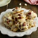 Cranberry cookies piled high on a white plate.