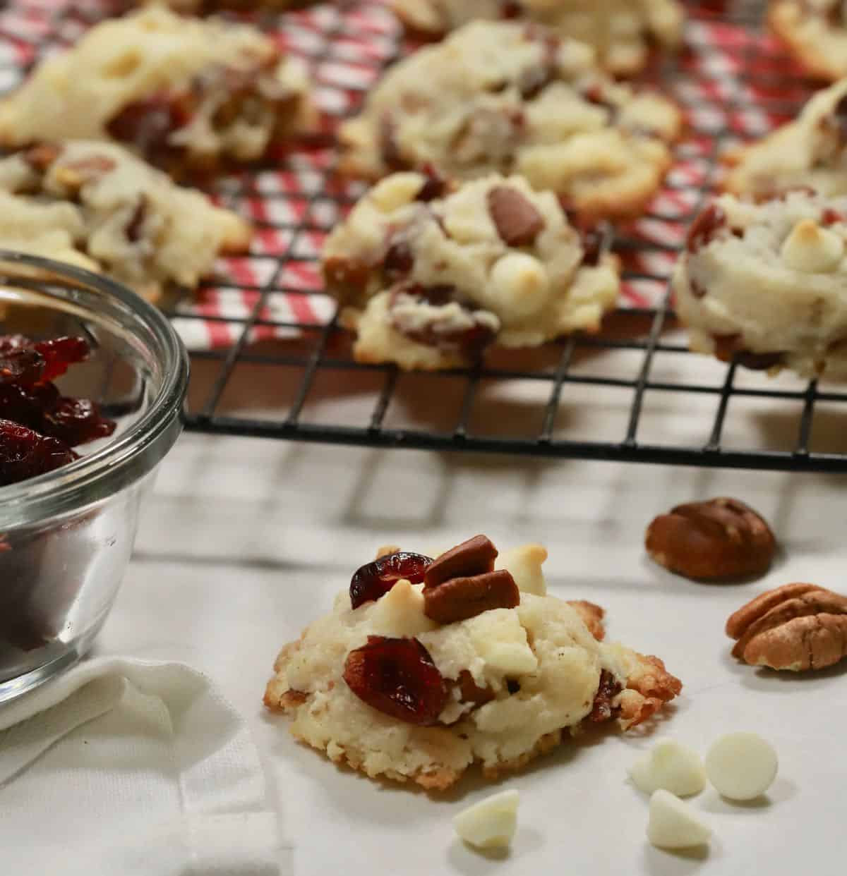 Baked cranberry cookies cooling on a wire rack. 