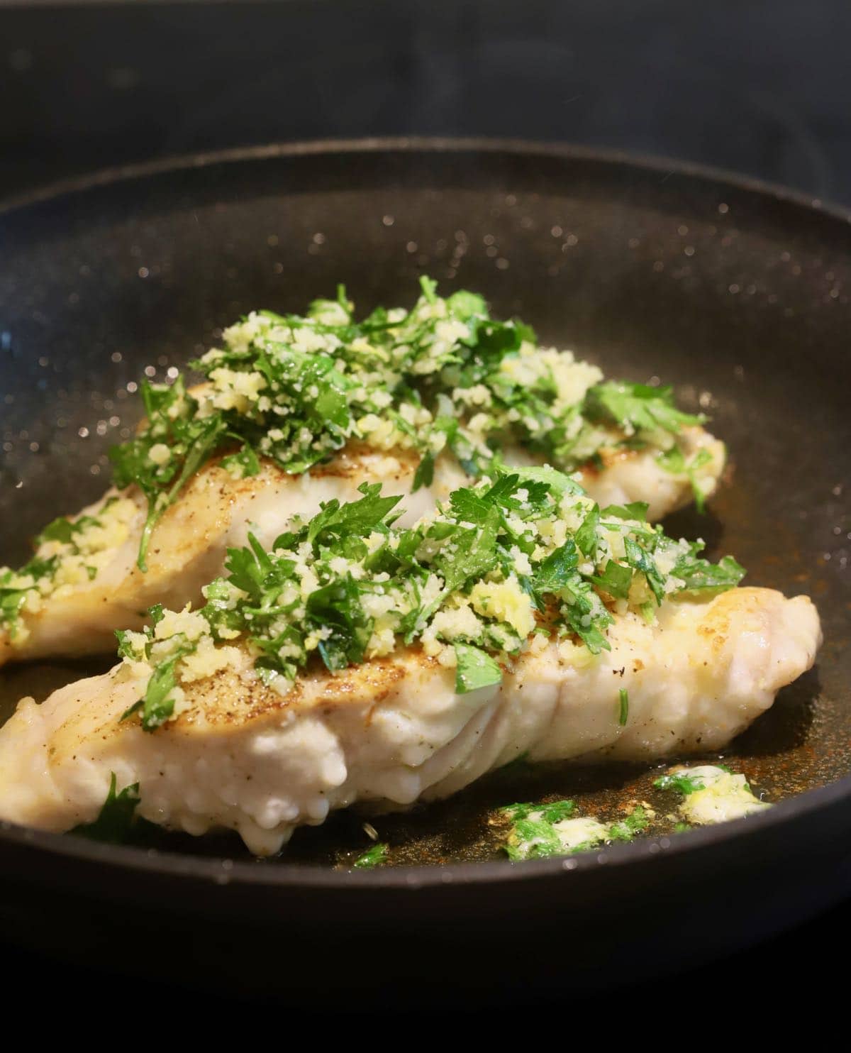 Two grouper fillets topped with a gremolata mixture.