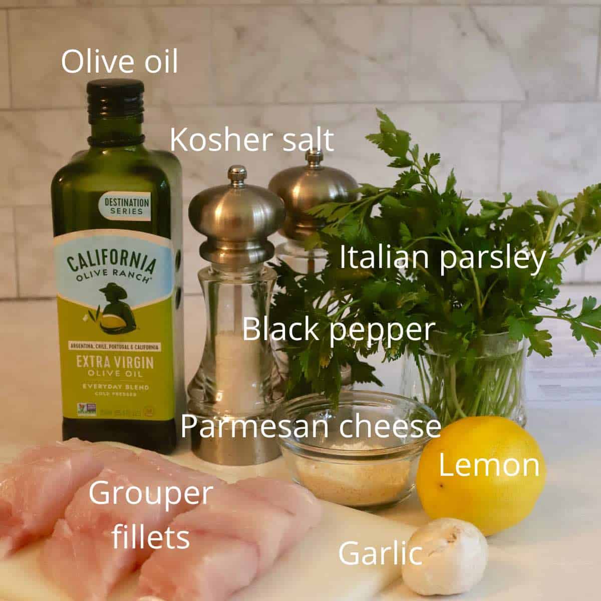 Ingredients like fish fillets, lemon and parsley on a cutting board. 