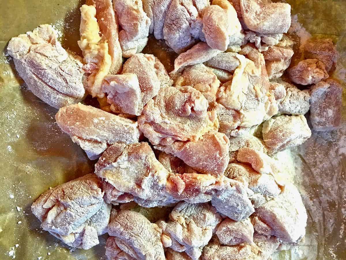 Pieces of chicken coated with flour. 