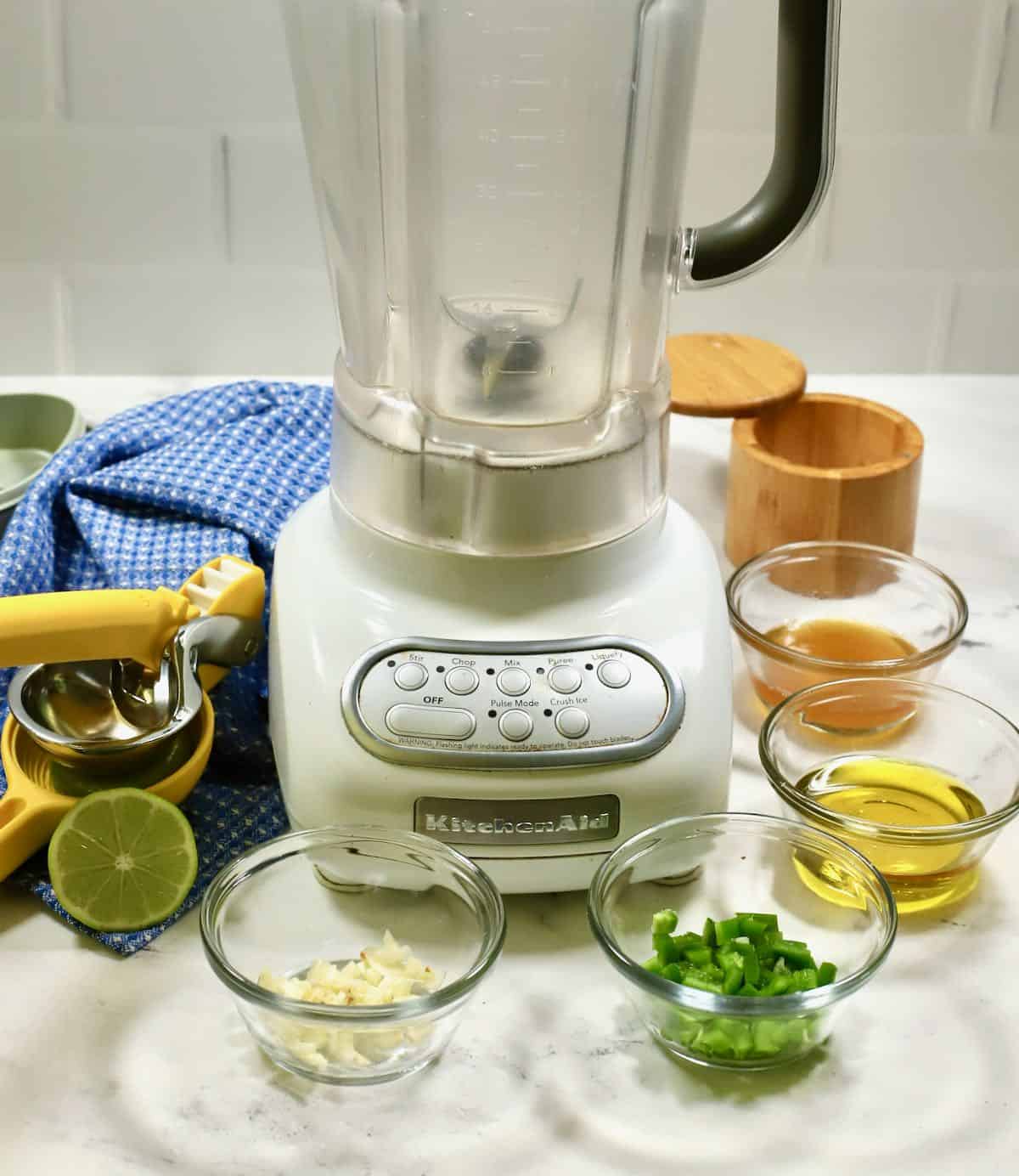 A blender with salad dressing ingredients. 