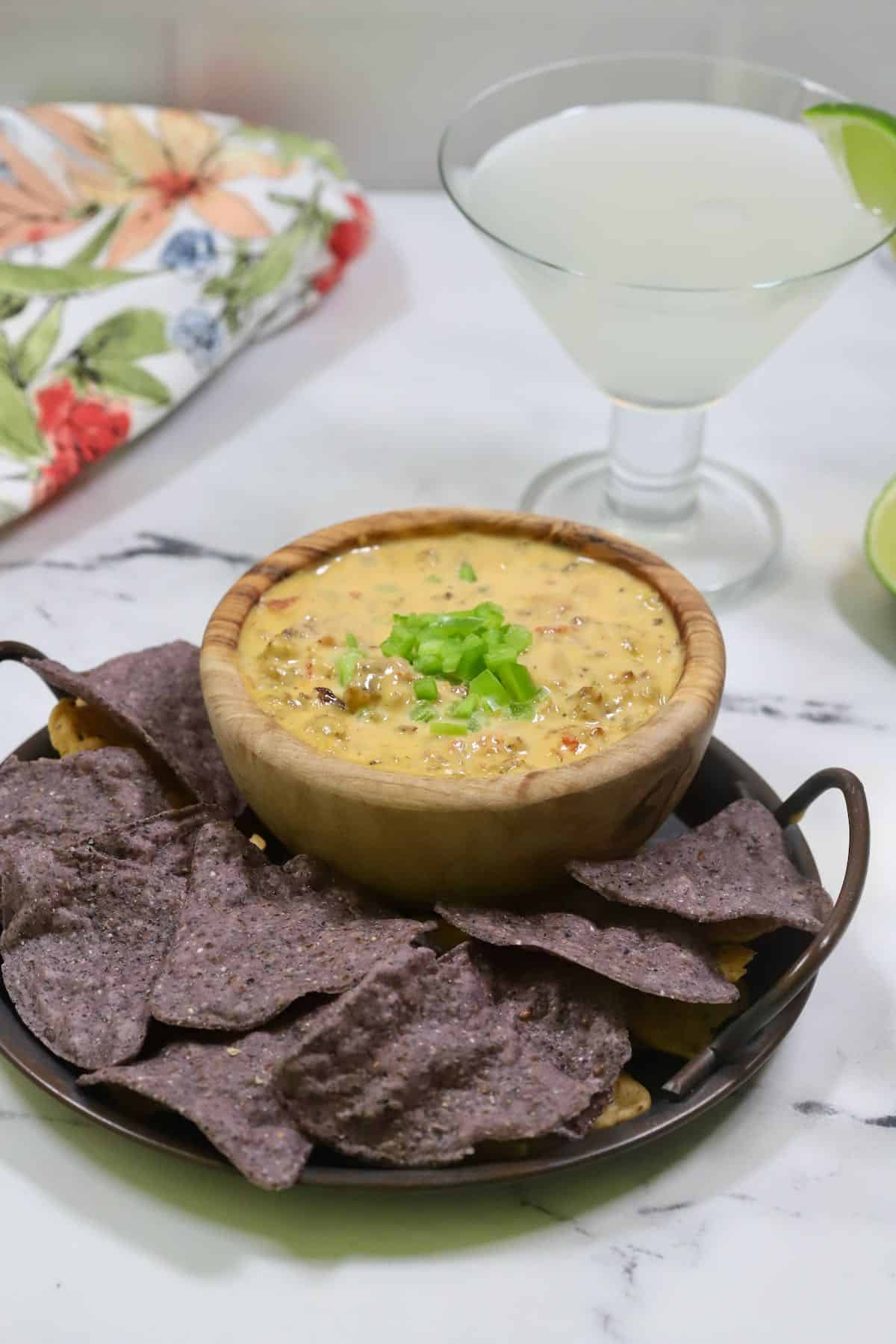 Smoked queso dip surrounded with chips.