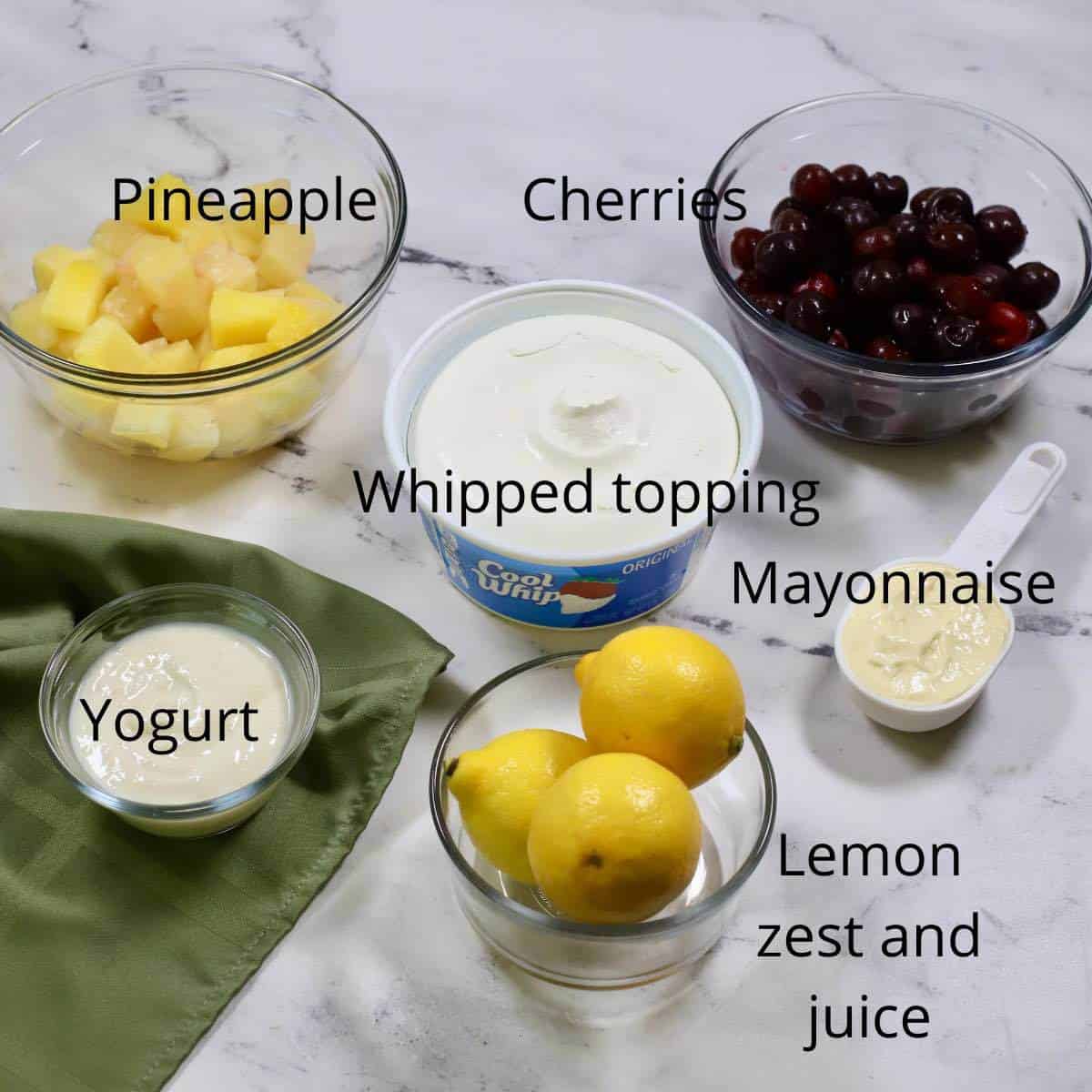 Ingredients for a frozen fruit salad including cherries and pineapple. 