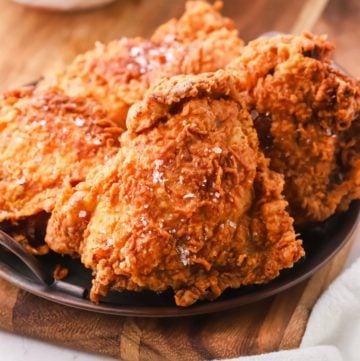 Four pieces of fried chicken on a plate.