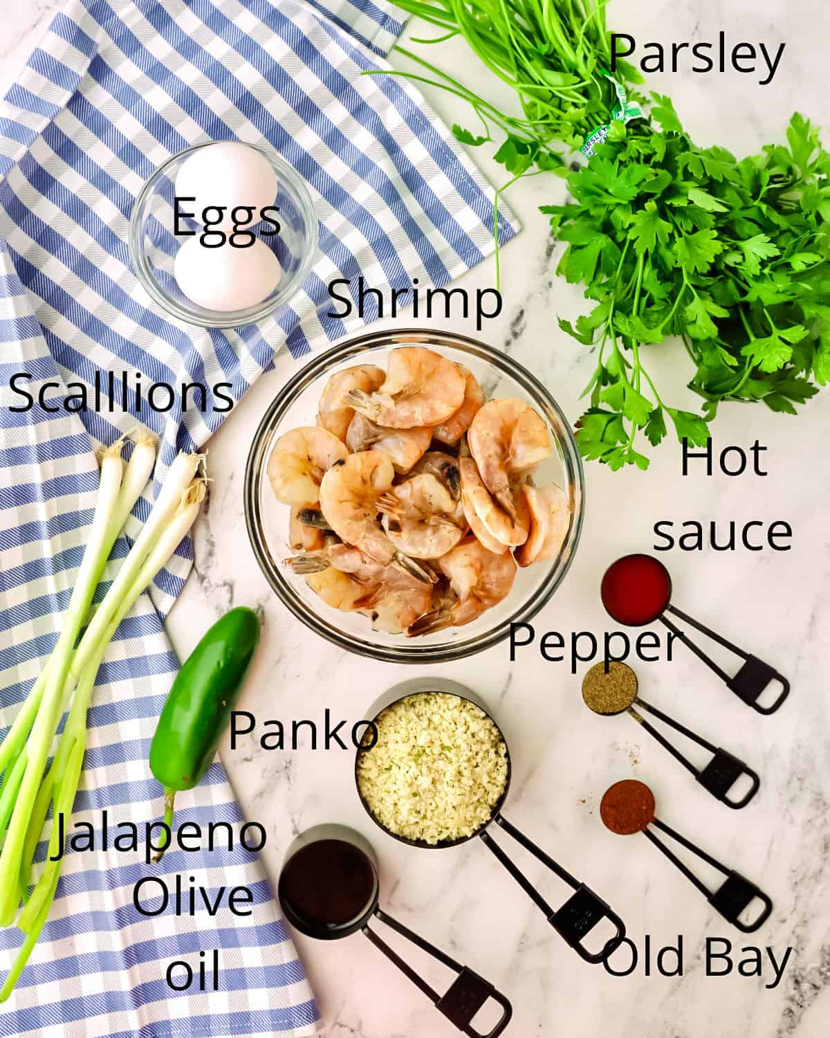 A bowl of shrimp, plus eggs, panko, and seasonings. 