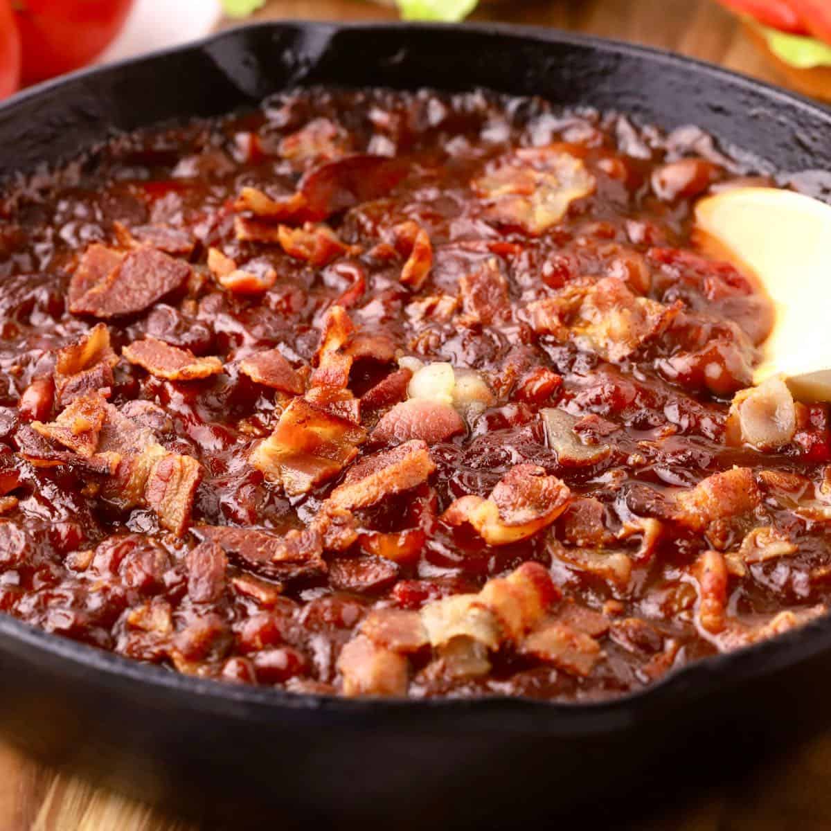 Smoked Baked Beans in a cast-iron skillet.