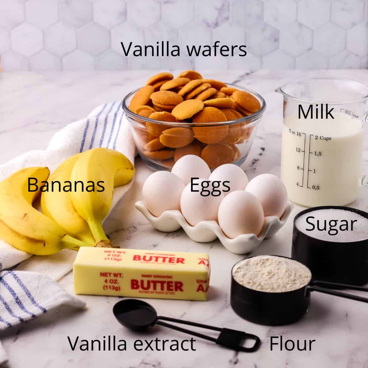 A bowl of vanilla wafers, bananas, milk and sugar. 