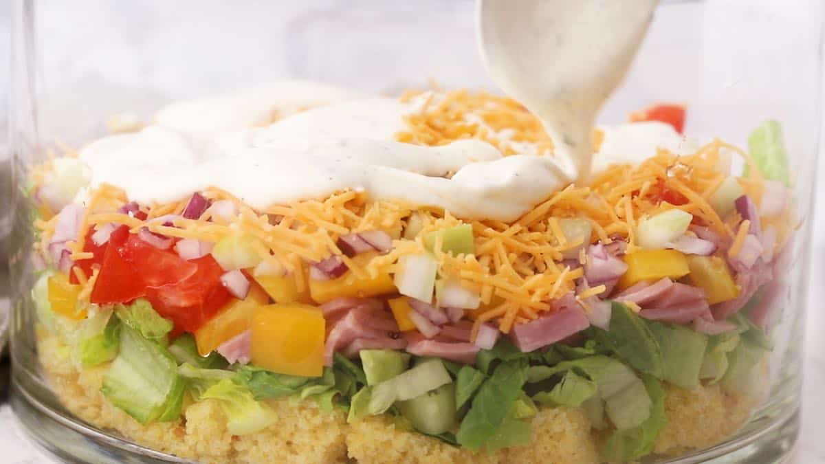 Adding ranch dressing to Cornbread Salad. 