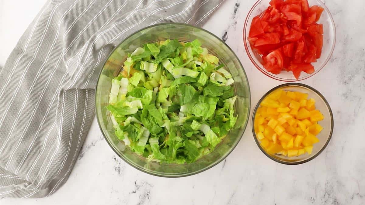 A layer of romaine lettuce in a trifle dish.