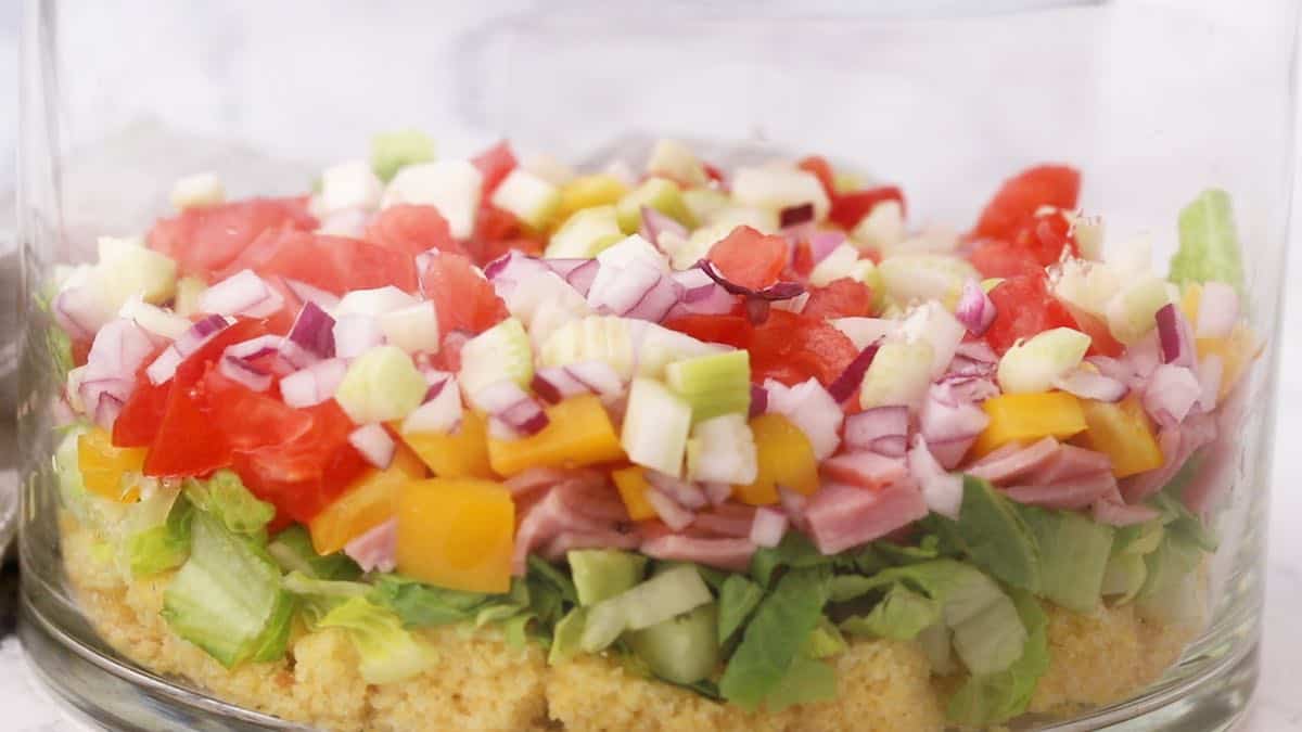 Layers of chopped onion and celery in a trifle dish.