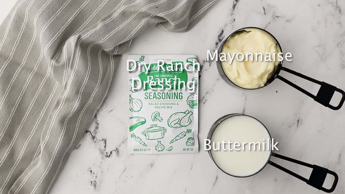 A package of dry ranch dressing, buttermilk,  and mayonnaise.