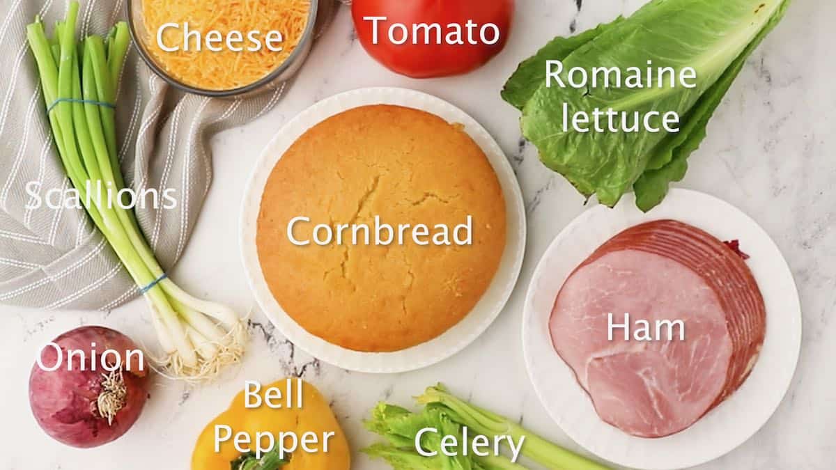 Cornbread, lettuce, scallions, ham and other ingredients for cornbread salad. 