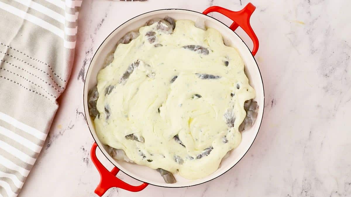 Shrimp and blue cheese sauce in a baking dish ready for the oven.