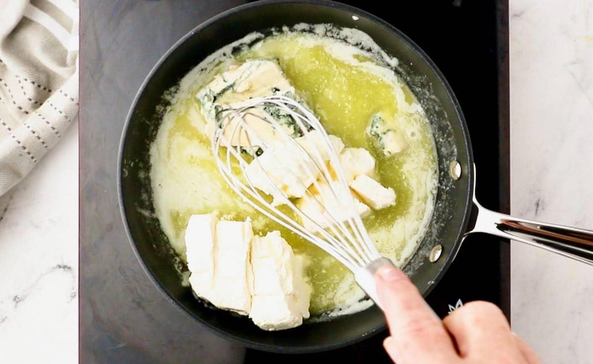 Melted butter, cream cheese and blue cheese in a skillet. 