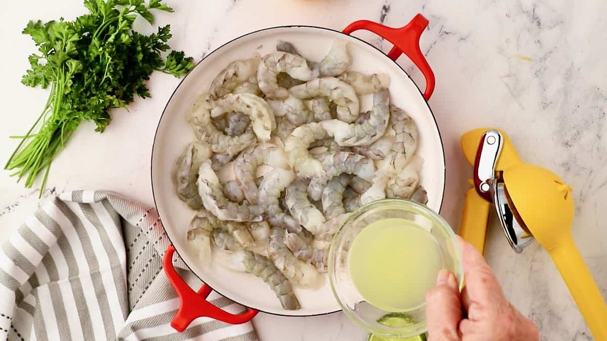 Raw shrimp in the bottom of a baking dish. 