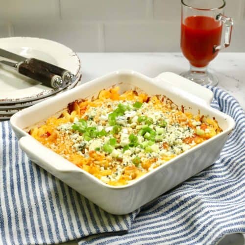 Buffalo Chicken Pasta Casserole on a blue and white kitchen towel.