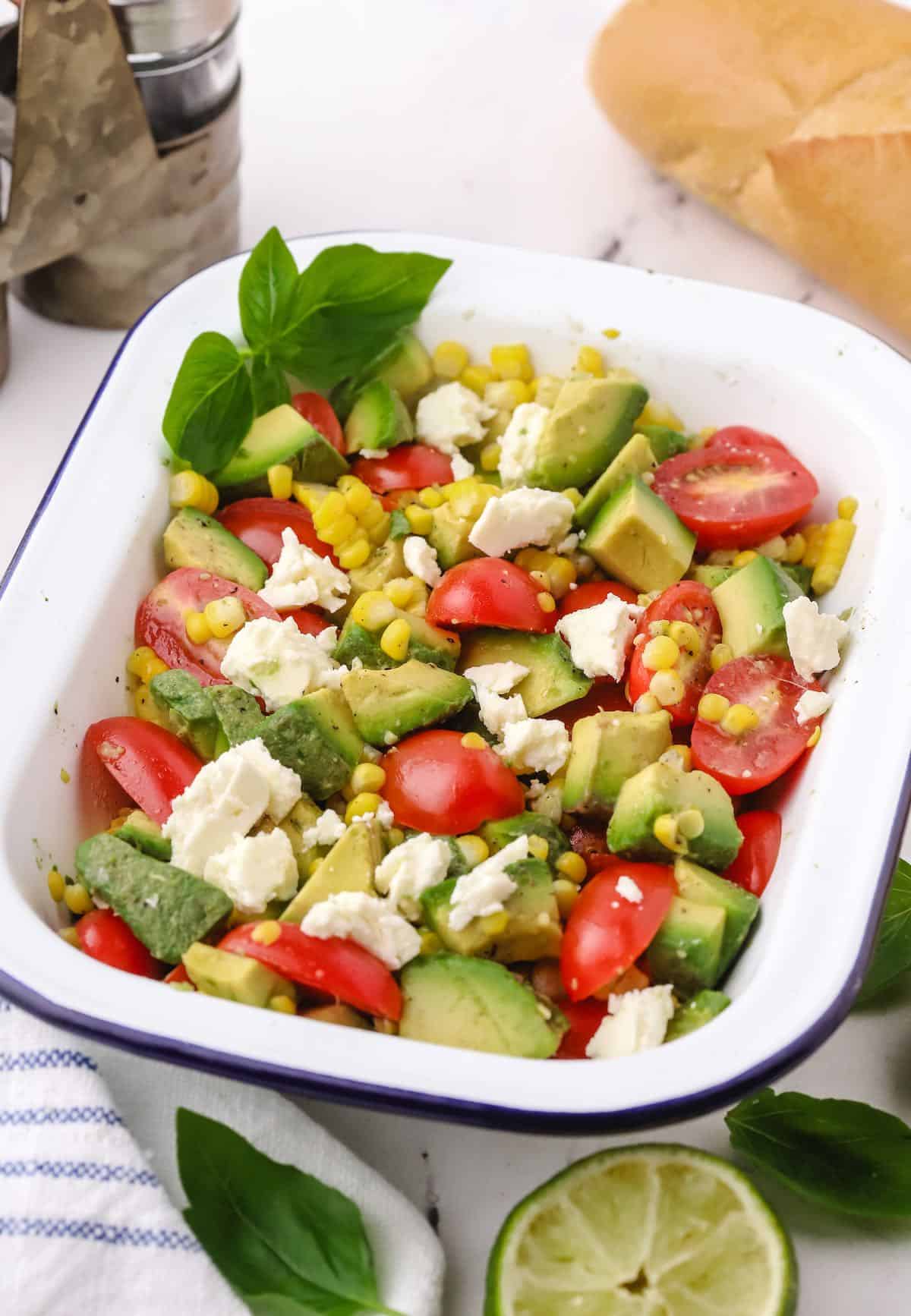 Tomato Avocado Feta Salad in a white serving dish.