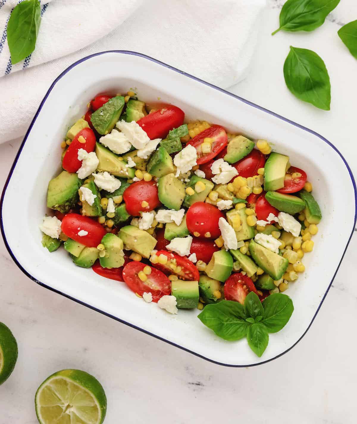 Tomato Avocado Feta Salad in a white dish.