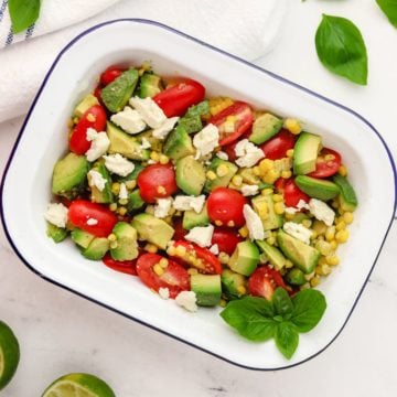 Tomato Avocado Feta Salad in a white serving dish.