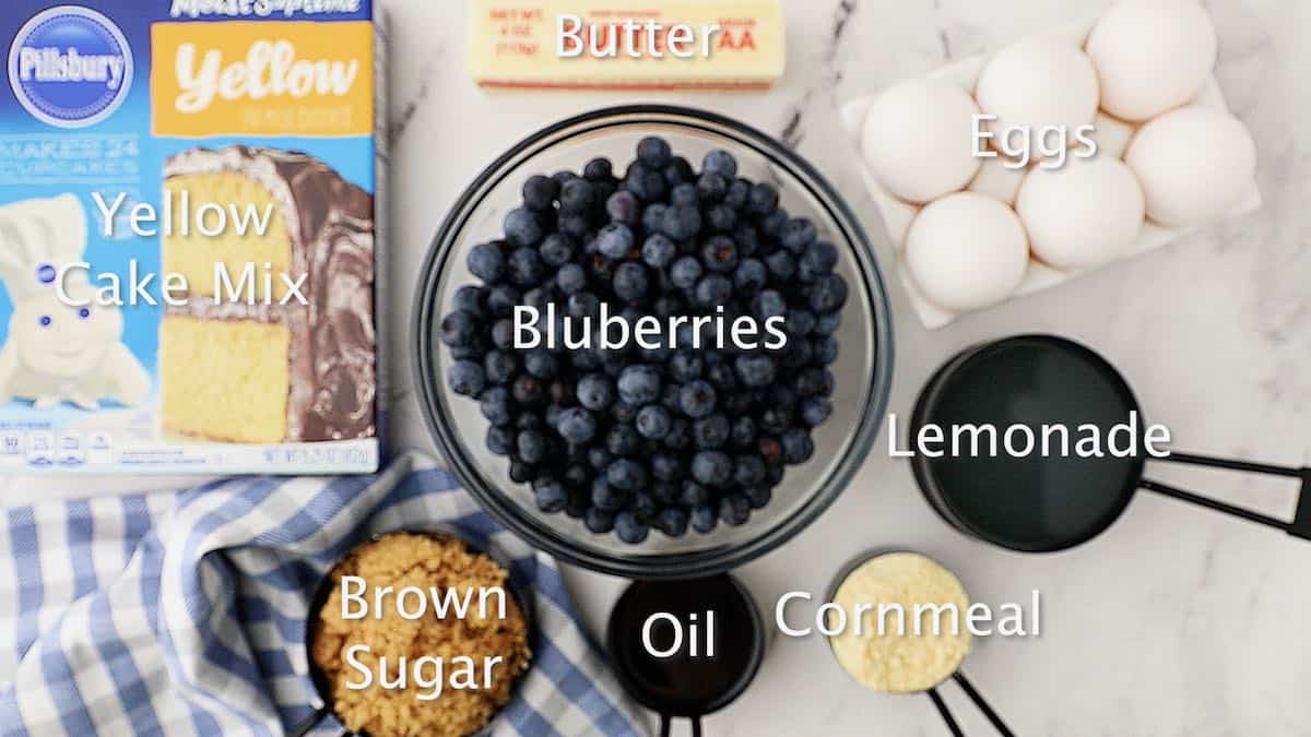 A large bowl of blueberries and a box of cake mix.