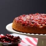 Cranberry upside down cake on a white cake platter.