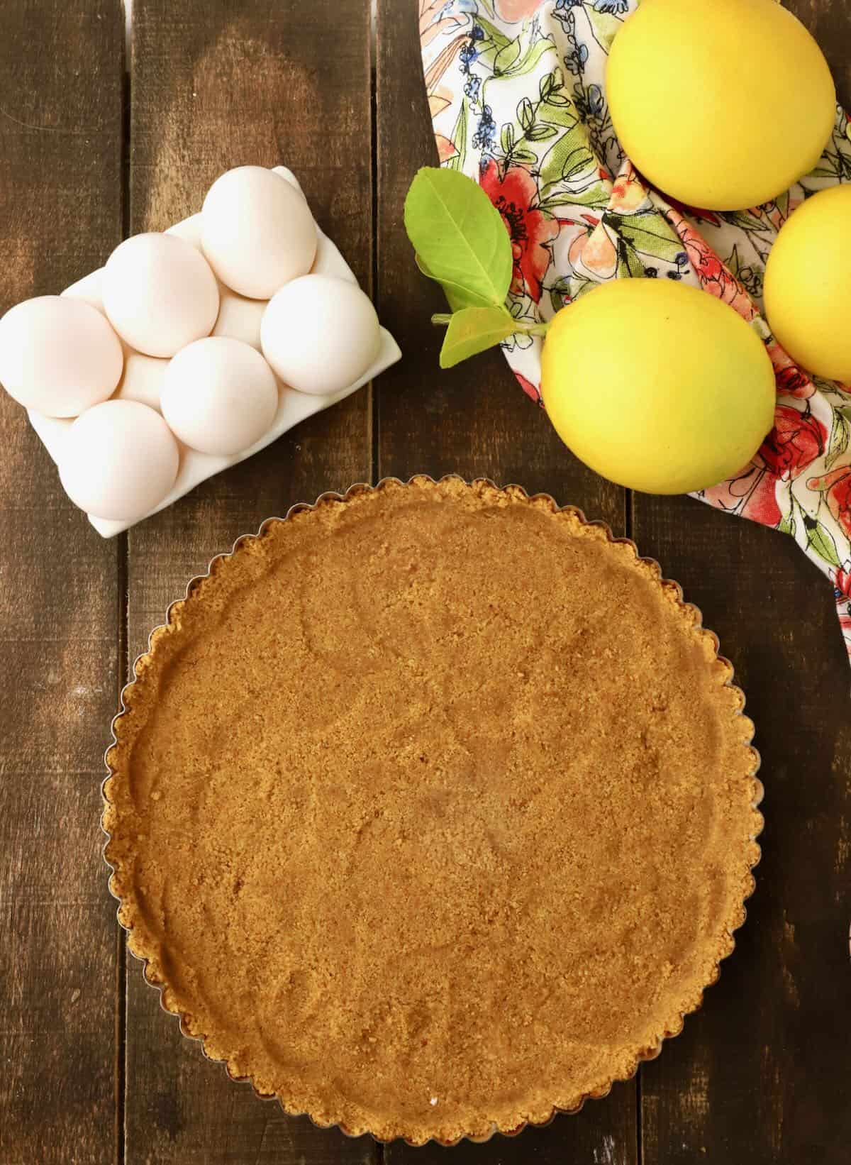 A tart pan with gingersnap cookie crumbs in it to make a tart crust. 