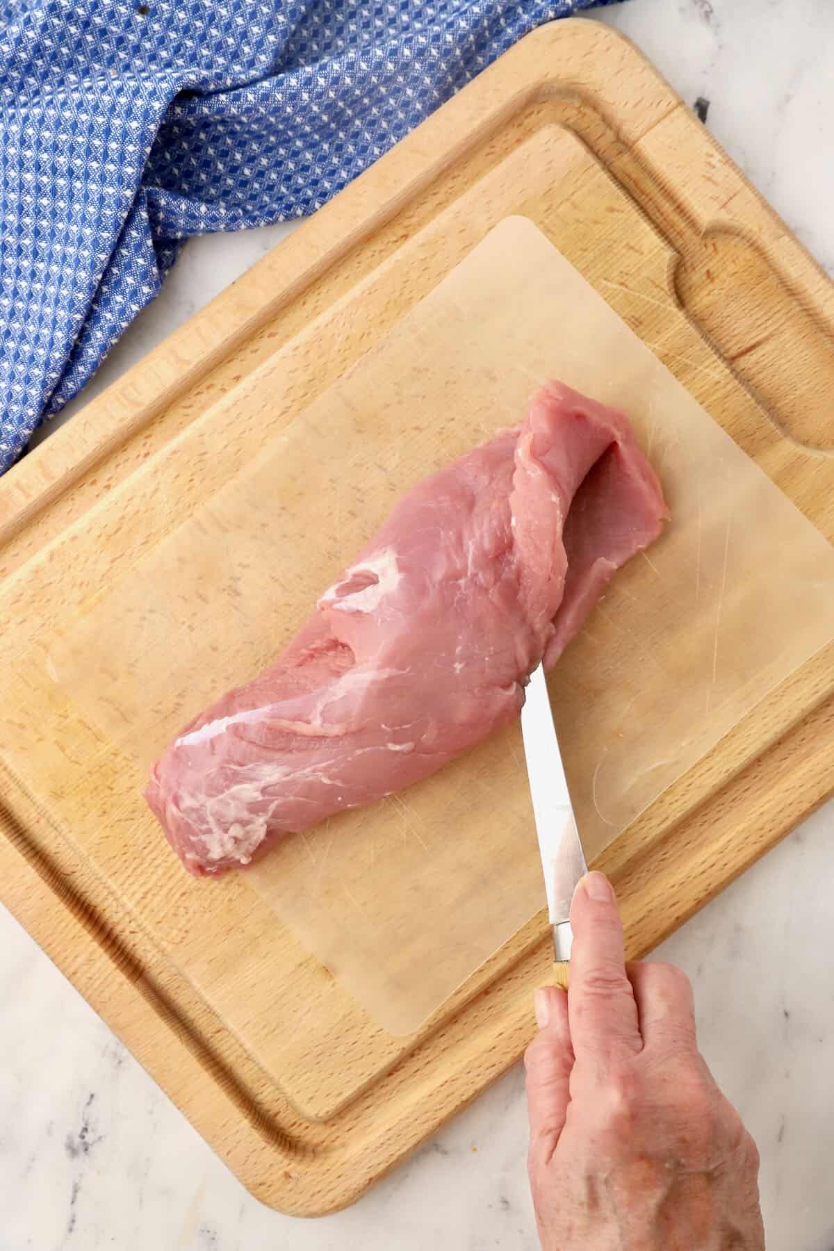 Using a fillet knife to slice a tenderloin open. 