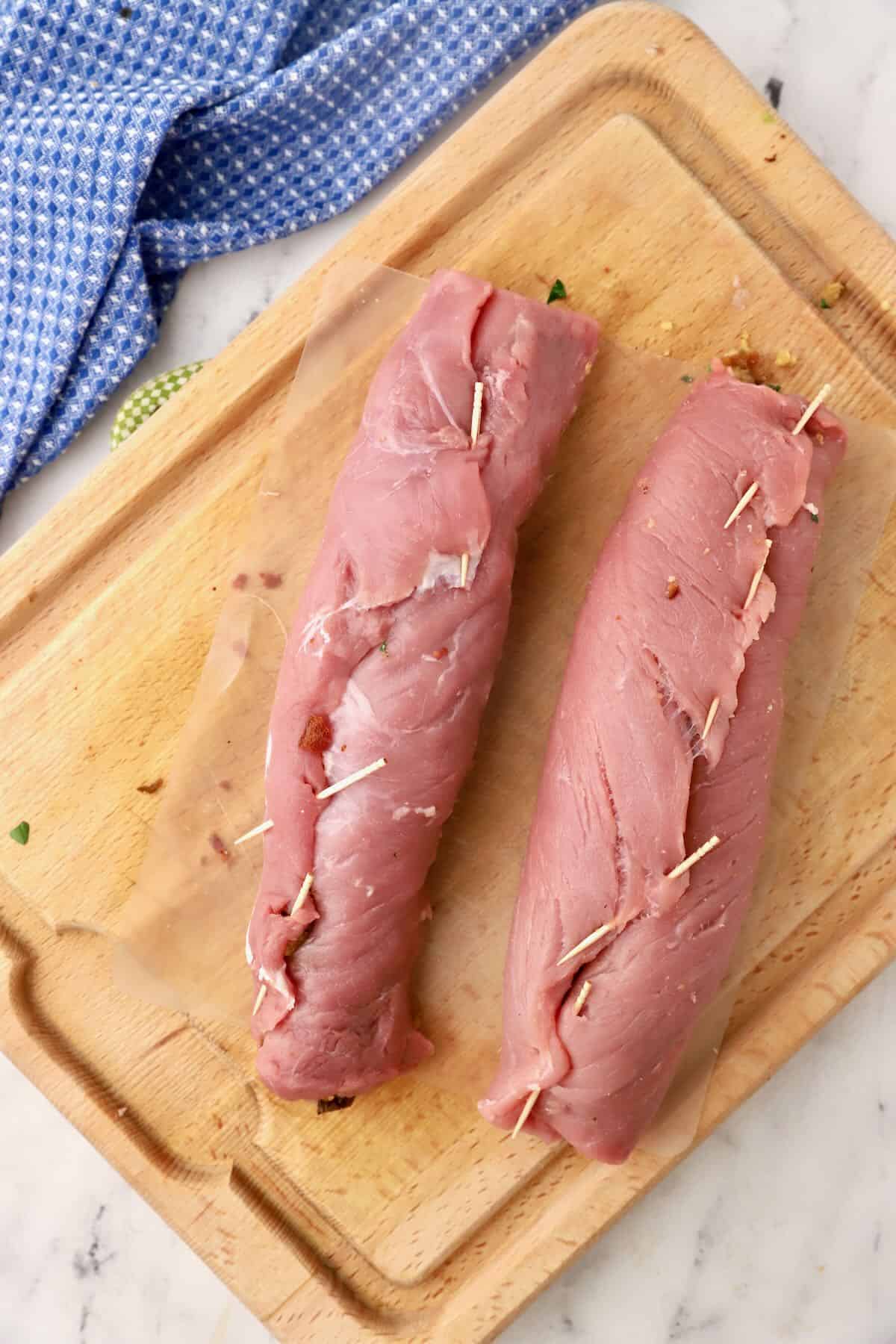 To stuffed pork tenderloins with toothpicks holding them closed. 