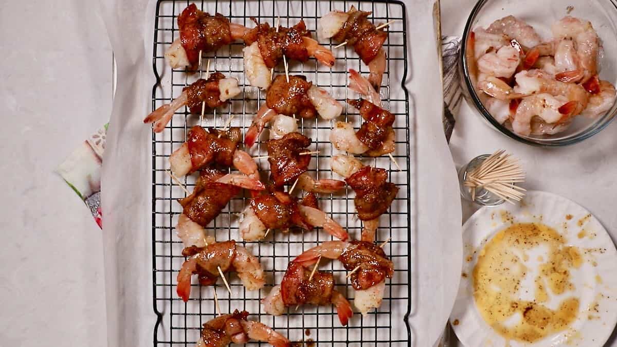 Shrimp wrapped with bacon on a wire rack. 