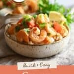 A bowl of creamy Cajun shrimp with a cream sauce, peppers, and onions, plus text.