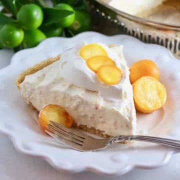 A slice of kumquat pie garnished with candied kumquat slices.