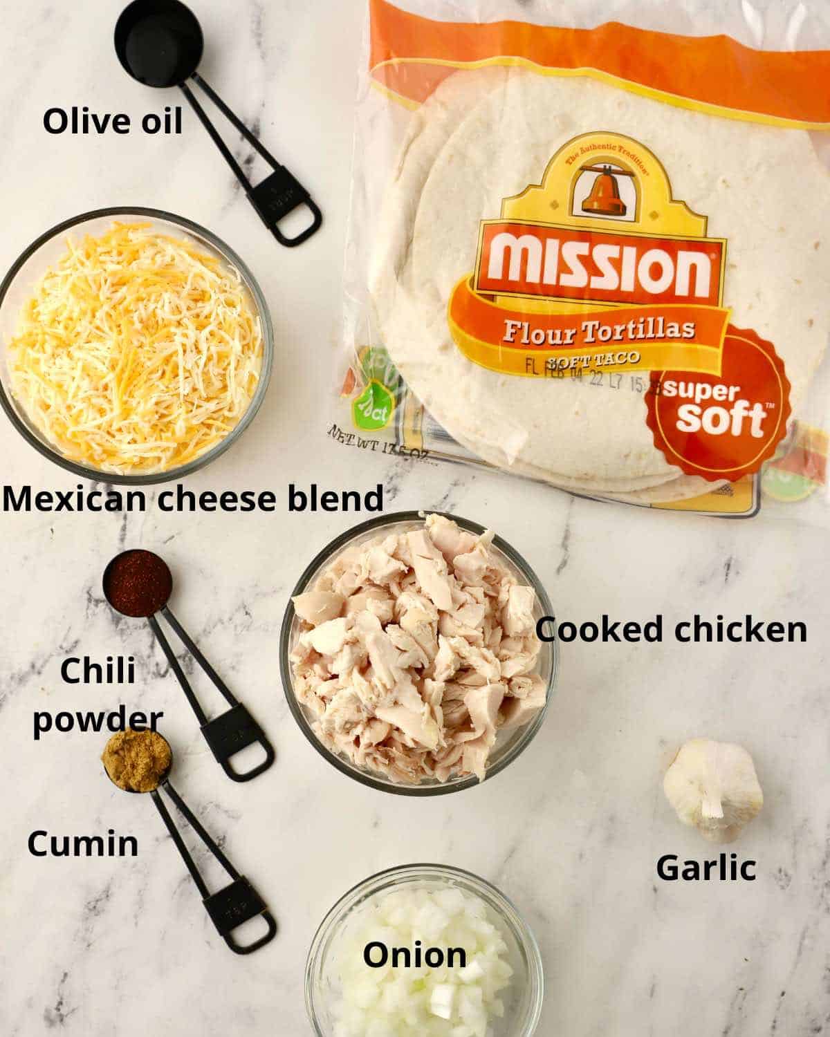 Ingredients for chicken enchiladas including tortillas and shredded cheese. 