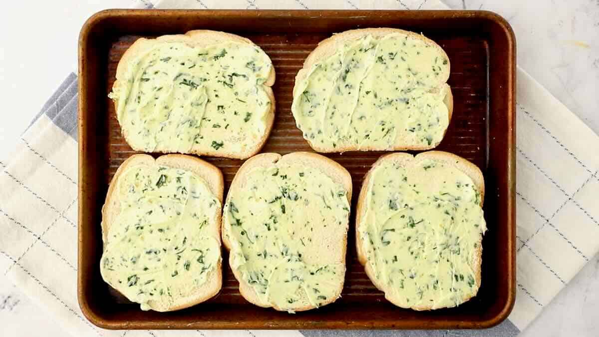 Slices of bread covered with garlic butter. 