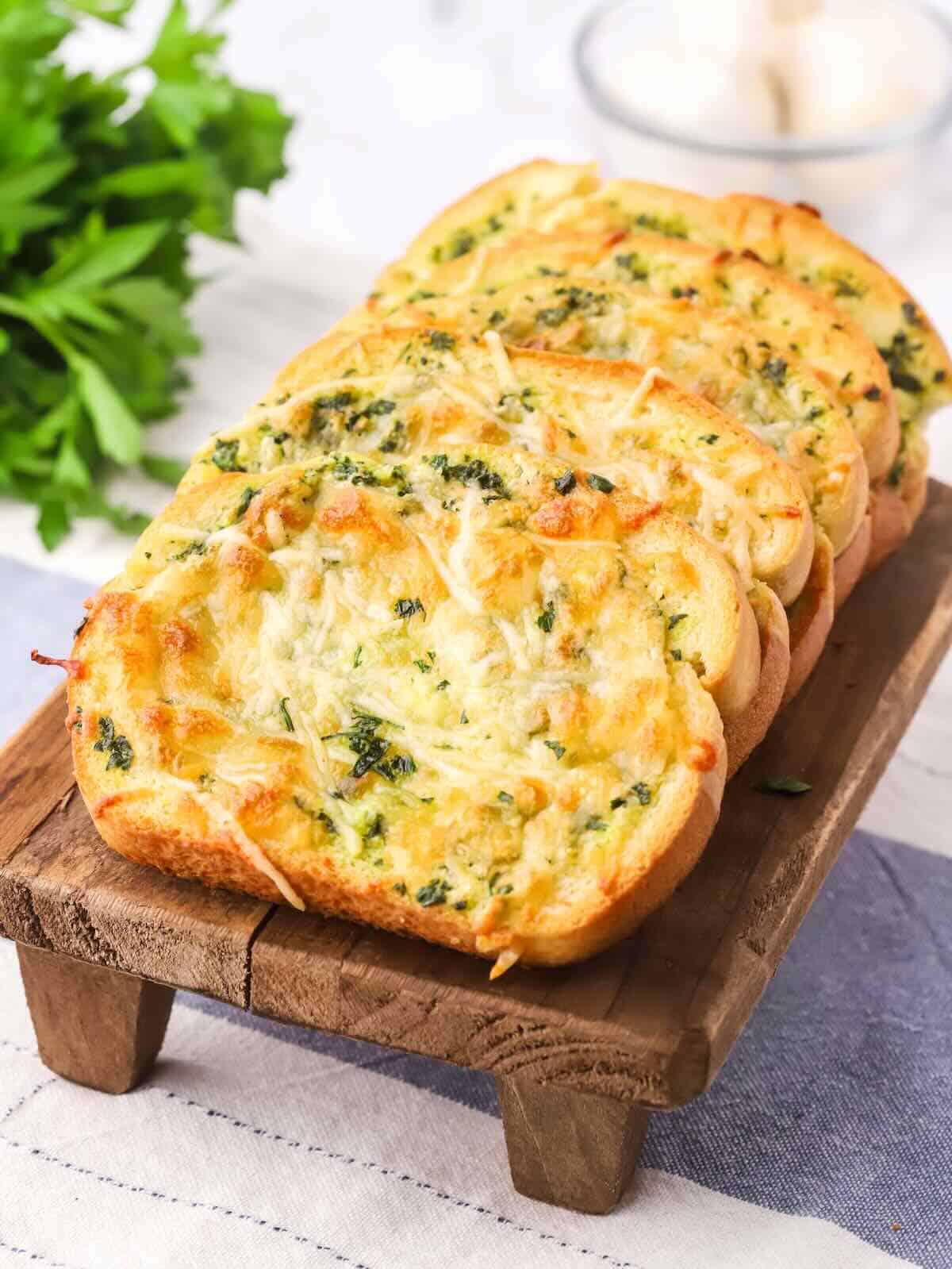 Slices of Texas Toast Garlic Bread on a  cutting board. 