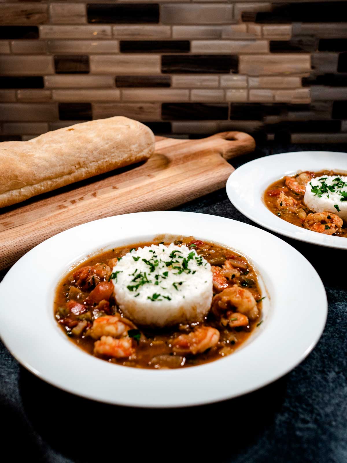 Shrimp Etoufee in a white bowl over rice. 