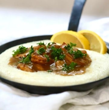 BBQ shrimp and grits in a skillet.