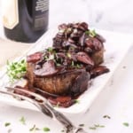 Two fillet mignons topped with red wine mushroom sauce.