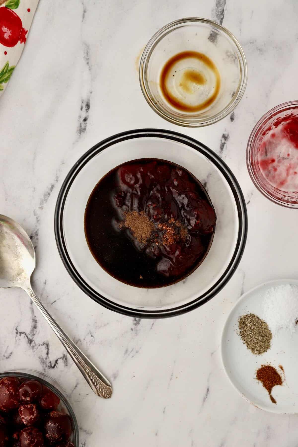 Cherry preserves and balsamic glaze in a small bowl. 